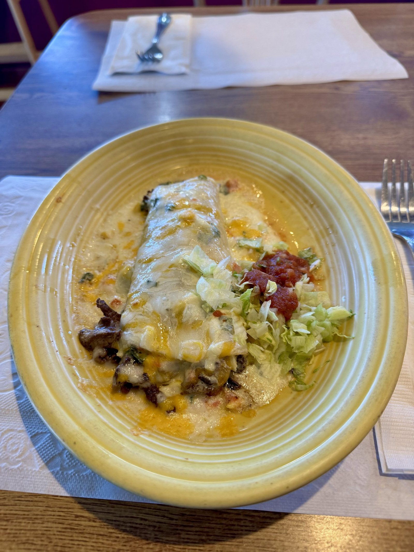 Chimichanga smothered in cheese sauce