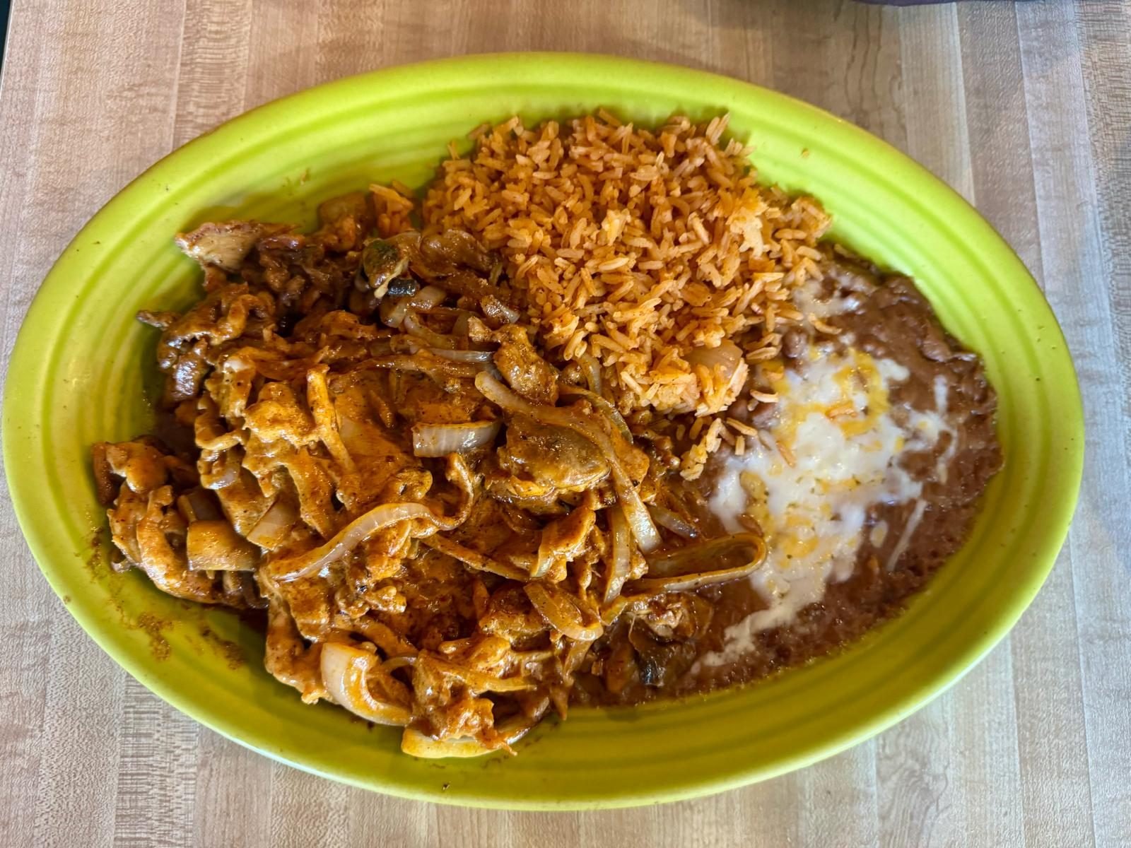 Chipotle chicken with grilled onions, rice and beans