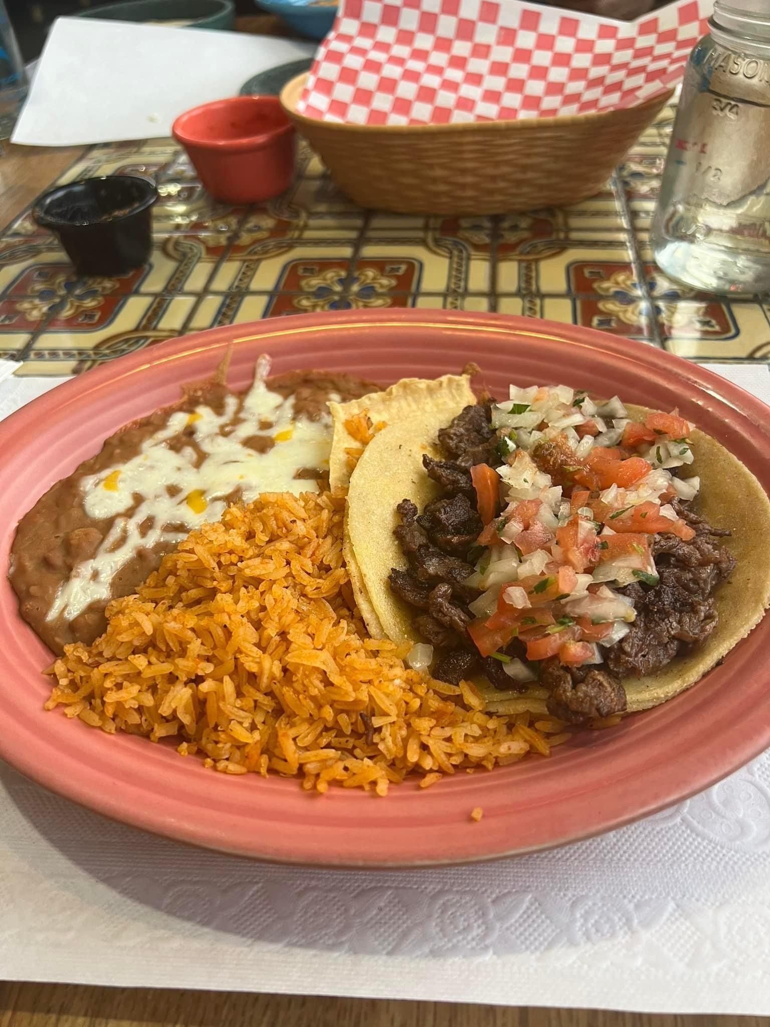 Combination plate with rice, beans and a taco with pico de gallo