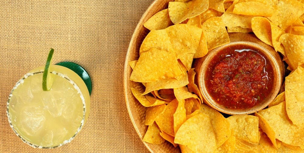 Agave margarita served with tortilla chips and house salsa